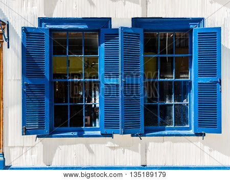 Typical smooth facade covered in zinc and large single-hung sash (guillotine) windows of the houses in Valparaiso Santa Lucia Hill of historical shell declared World Heritage by UNESCO. Chile