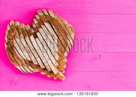 Heart Shaped Sliced Bread On Pink Background