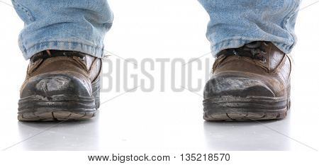 man's legs wearing work boots on white background