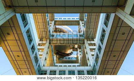 TOKYO JAPAN - NOVEMBER 27 2015: Fuji T.V. headquarters one of the most striking buildings in Japan. its' futuristic metallic clad building featuring a massive silver ball 32 metres in diameter