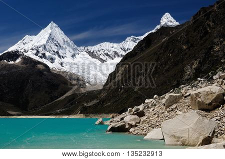 South America Beautiful Cordillera Blanca mountain. The picture presents lagoon Paron and snowcovered Piramide de Garcilaso peak Peru