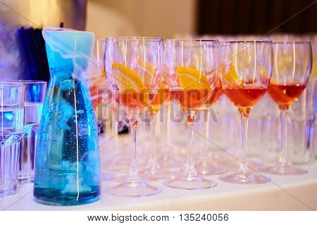 glasses of spritz aperitif aperol red cocktail with orange slices and ice cubes on wood table