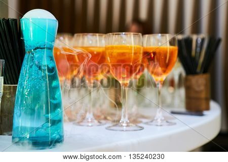 glasses of spritz aperitif aperol red cocktail with orange slices and ice cubes on wood table
