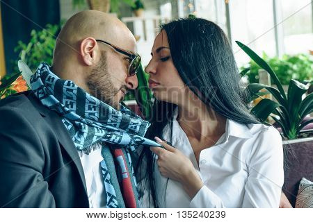 Arab man hugs and kisses a beautiful girl in the restaurant