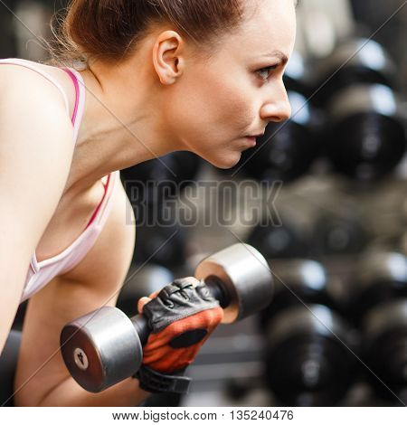 Young Woman Doing Exercise In Fitness Center