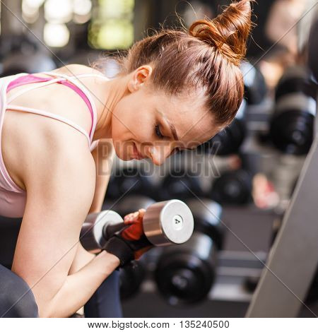 Young Woman Doing Exercise In Fitness Center