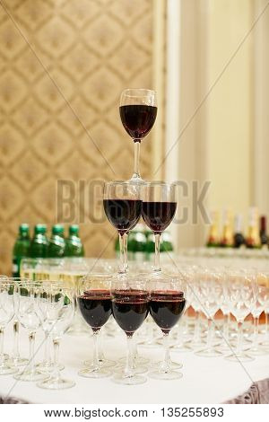 pyramid of glasses with red wine on table