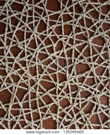 braided doily under a pot of flowers made by hand