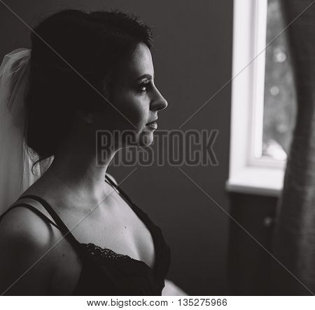 Bride sitting in a room and looking somewhere