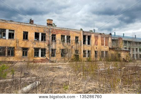 Old evicted and destroyed house with a ruined walls and broken windows