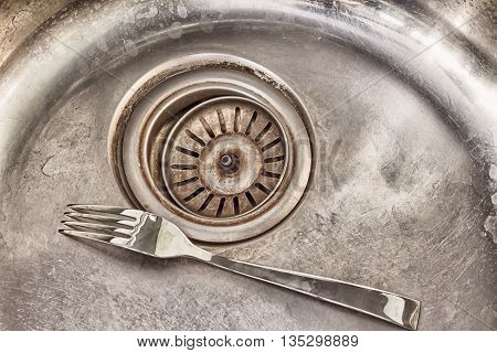 detail shot of a old dirty sink with scrubber inside.old sinkdrop in sink