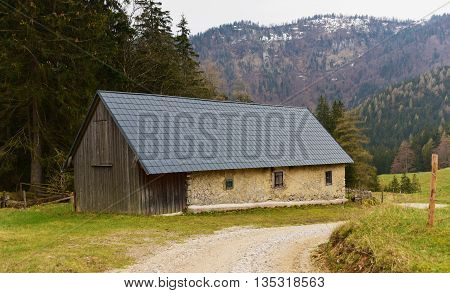 Alps stone cottage in April in rainy day