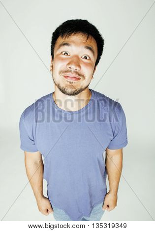 young cute asian man on white background gesturing emotional, pointing, smiling, lifestyle people concept, cheerfull mature guy making funy faces