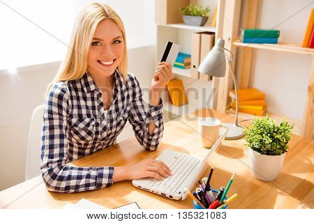 Cheerful Woman Holding Credit Card And Doing Banking