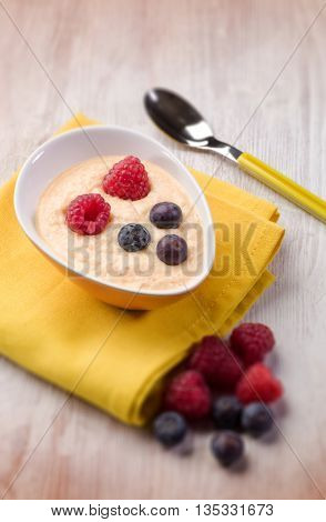 orange sorbetto with blueberry and raspberry, selective focus