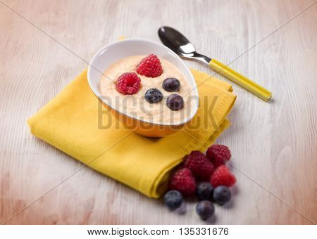 orange sorbetto with blueberry and raspberry, selective focus