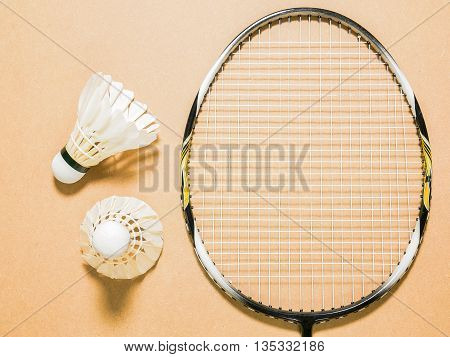 sports set of two shuttlecocks with badminton racket on plywood background