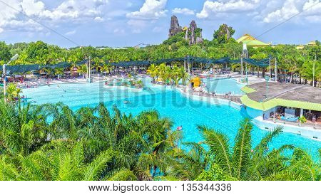Binh Duong, Vietnam - June 5th, 2016: Lots of tourists bathing water park, swimming enjoy artificial waves, this largest Artificial beach attracts tourists weekend resort in Binh Duong, Vietnam