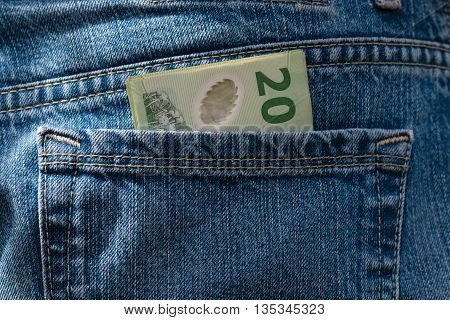 closeup of twenty dollar New Zealand banknote in jeans pocket