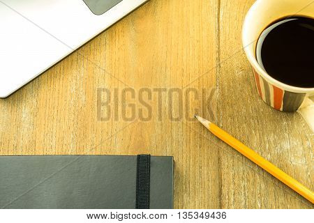 Topview shot of laptop and notepad on a desk