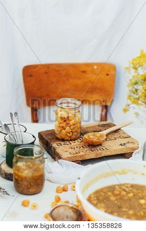 Raspberries Jam. Female Hand Making Jam, On A Rustic White Table