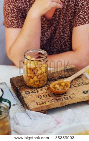 Raspberries Jam. Female Hand Making Jam, On A Rustic White Table