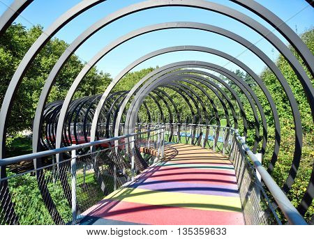 Slinky Springs Bridge. Modern bridge with multicolored gangway.