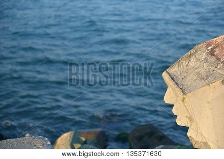 Close Up Of Breakwater Made Of Concrete Tetrapods In The Sunset, With The Calm Sea In Background. Se