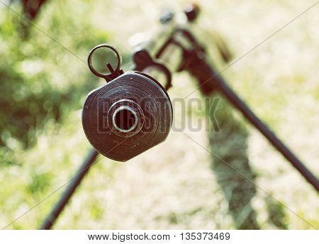 Close up photo of heavy sniper rifle from World War II. Gun scene. Gun barrel. Armed conflict. Military theme. Portable weapon. Retro photo filter. Shooting position.