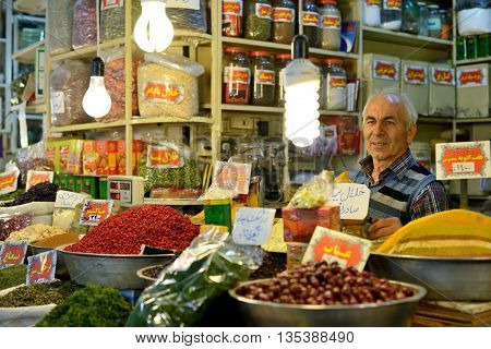 ISFAHAN - APRIL 19: Unknown man trades traditional iranian food and spices in market (Bazaar) in Isfahan Iran on April 19 2015. Bazaar is the most important tourist attraction in Isfahan Iran.