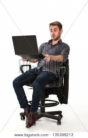 clerk enjoys working with a laptop in hand, sitting on a chair, studio white background