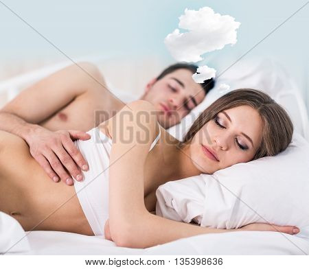 Woman with thoughts cloud sleeping in bed with her boyfriend