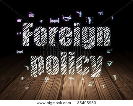 Political concept: Glowing text Foreign Policy,  Hand Drawn Politics Icons in grunge dark room with Wooden Floor, black background