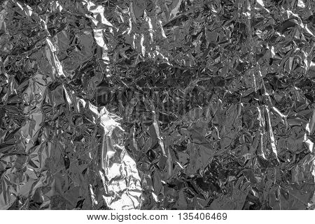 Shiny silver white grey gray paper foil decorative texture background: Bright brilliant festive damaged folded metallic look textured backdrop: Metal steel like material pattern surface for design decoration