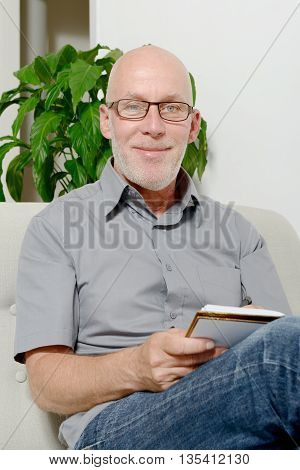 a middle aged man in the sofa