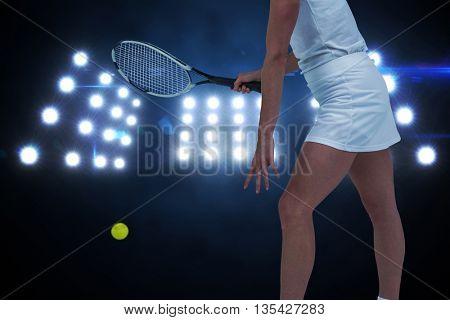 Athlete playing tennis with a racket against composite image of spotlight