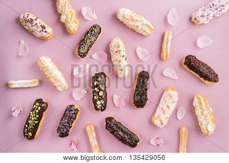 Eclairs with chocolate ganache and icing with different toppings