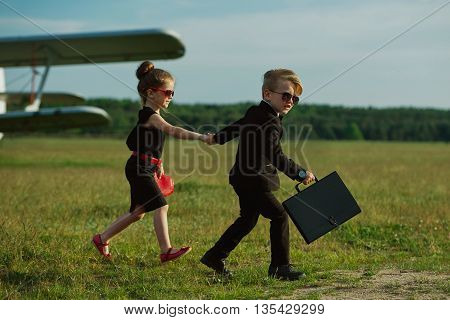 photo of young boy and girl playing spy