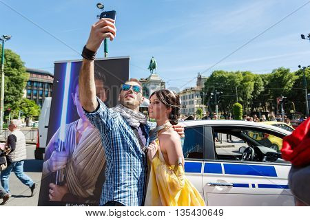Milan Italy - May 04 2016: Couple of young people makes selfie during the parade of costumed Star Wars on the street of Luca Beltrami