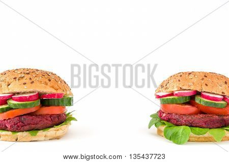 Vegan beetroot burger with lamb's lettuce, tomato, cucumber and radish isolated on white background
