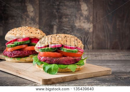 Veggie beet burgers on a rustic wooden table