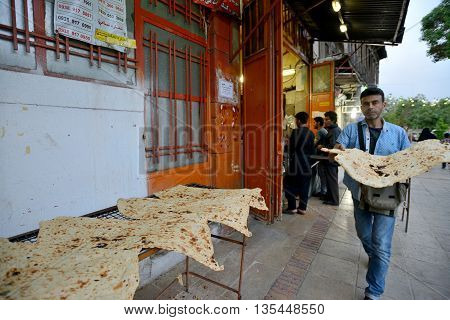 SHIRAZ - APRIL 14: Unknown people trades bread in a market (Vakil Bazaar) in Shiraz Iran on April 14 2015. Vakil Bazaar is the most important tourist attraction in Shiraz Iran.