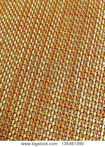 A woven plastic place mat close up.