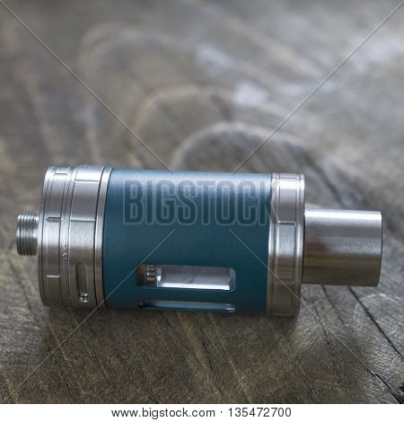 E-cigarette head on wooden surface close up