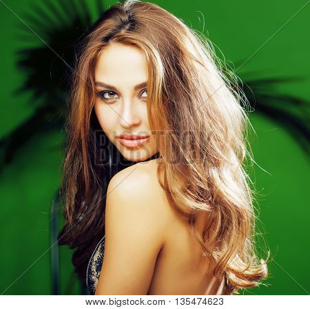 young cute blonde woman on green palm background smiling happy, lifestyle peole concept close up