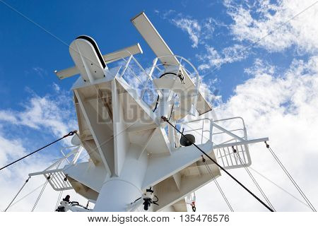 Sattelite communication antenna and radar mast on the top deck of the ship.