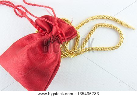 Jewel and gold bag on white background