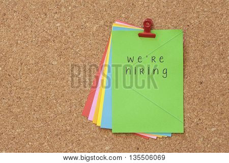 we're hiring on color sticker notes over cork board background