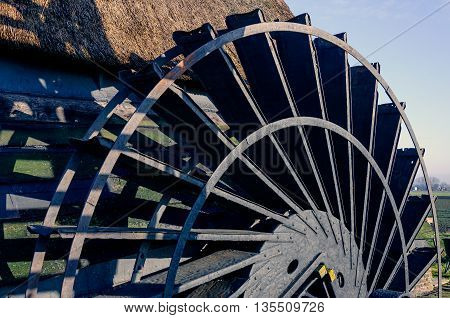 Close-up of the paddlewheel of a historic Dutch polder windmill built in 1699. It is a sunny day in the winter season.