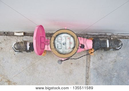 Pink water meter and plumbing in home
